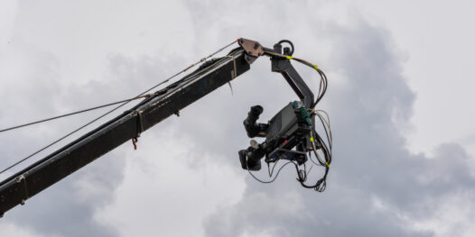 cinema-television-camera-suspended-broadcast-crane-with-cloudy-sky-background